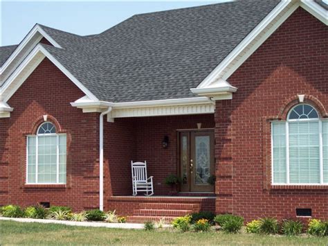 red brick house light grey metal roof|black shingles on brick house.